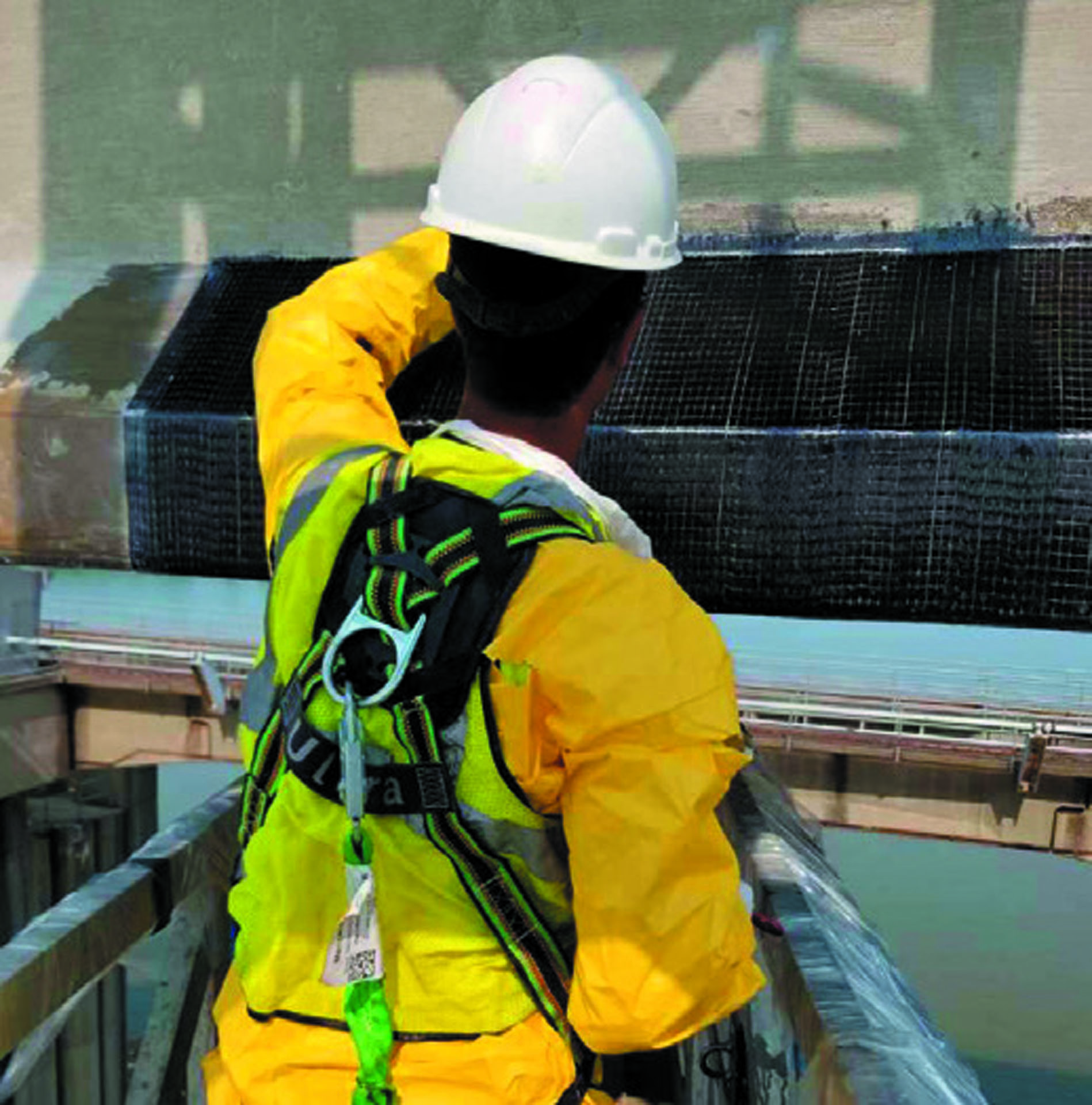 Hydratech’s laborer adding finishing layers of thickened Tyfo® S to corners and edges