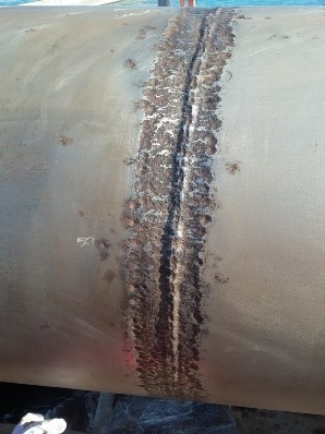 The surface of the damaged line is cleaned and polished before the composite installation begins.