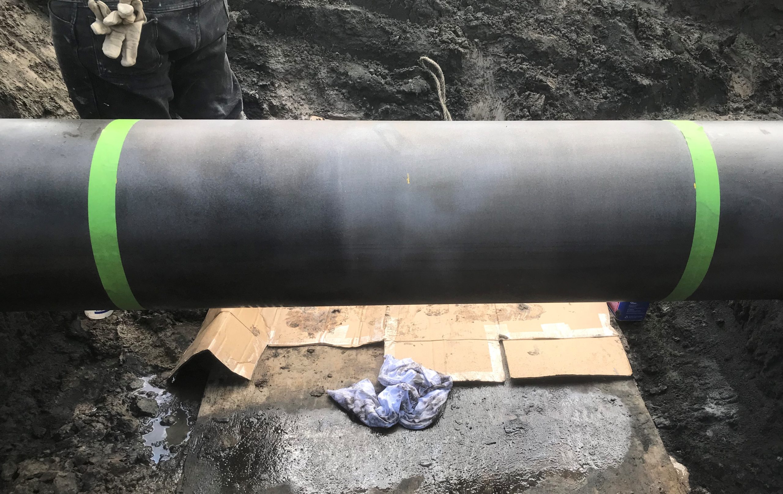 Technicians prepared the pipe surface to a near-white profile and wiped it with acetone in preparation for the composite installation.